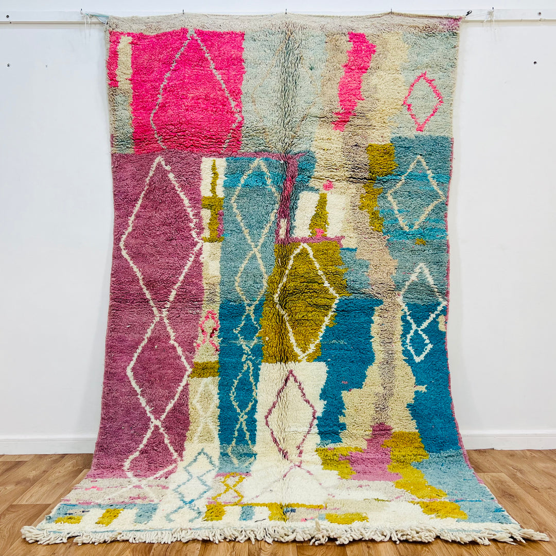 Vintage Moroccan rug, 8.5x5.3 ft, pink & blue abstract, Berber-inspired design with diamond motifs, natural wool, vibrant colors.