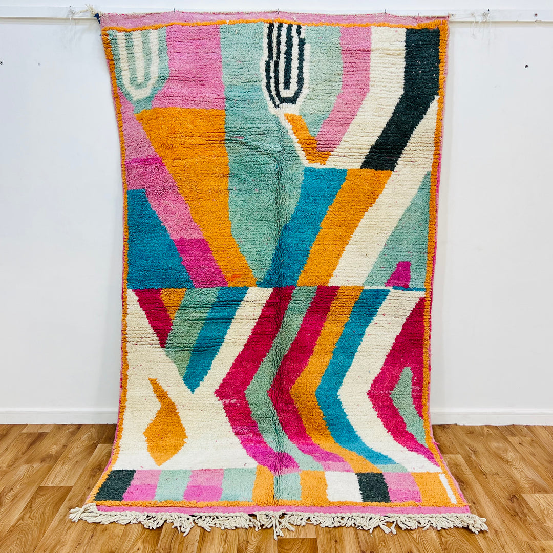 Colorful vintage Moroccan rug 8.3x5 ft, handmade wool, zigzag and abstract design in orange, teal, fuchsia, cream, black tones.