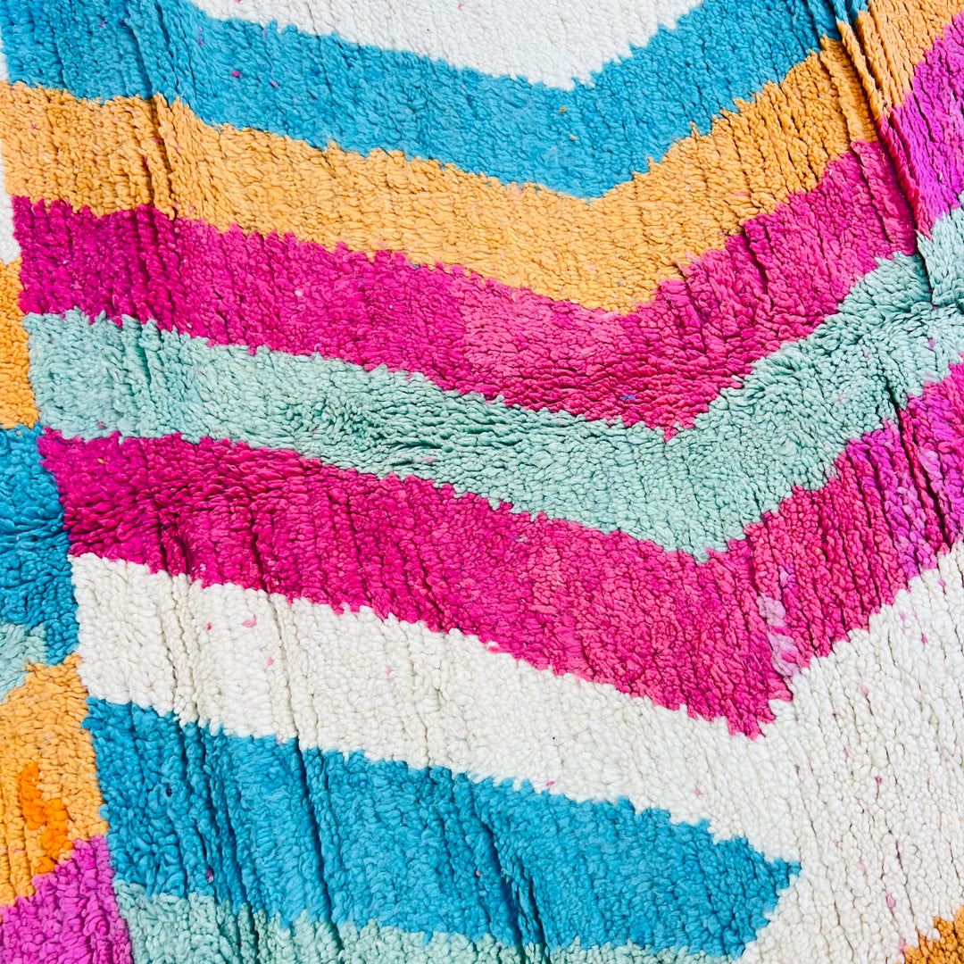 Colorful vintage Moroccan rug with pink, teal, orange zigzag patterns, handmade wool, 8.3x5 ft, traditional Berber design.