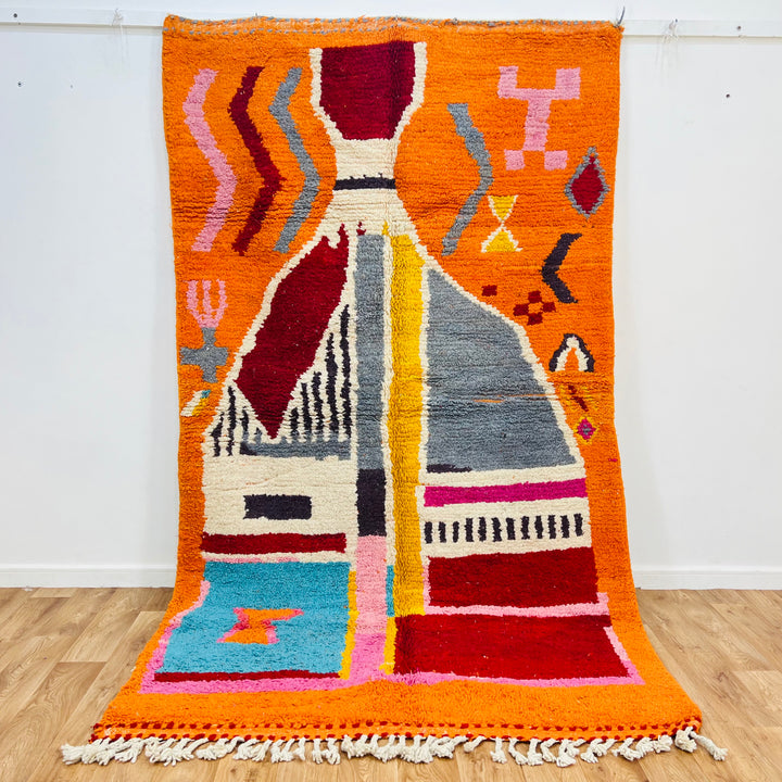 Vintage Moroccan rug with orange abstract design, 9x5 ft. Handcrafted Berber carpet with vibrant colors and tribal patterns.