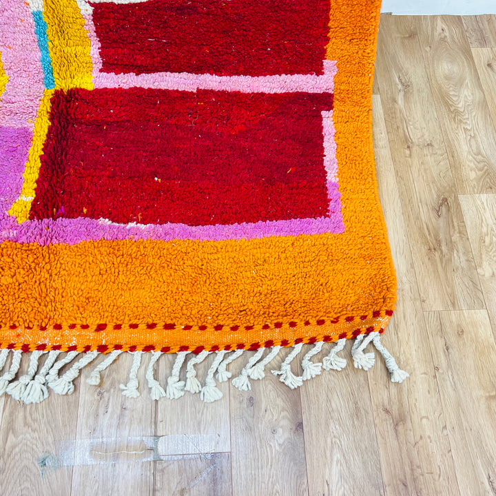 Vintage Moroccan rug 9x5 ft with orange abstract design and vibrant colors, handcrafted from natural wool. Perfect Moroccan Berber decor.