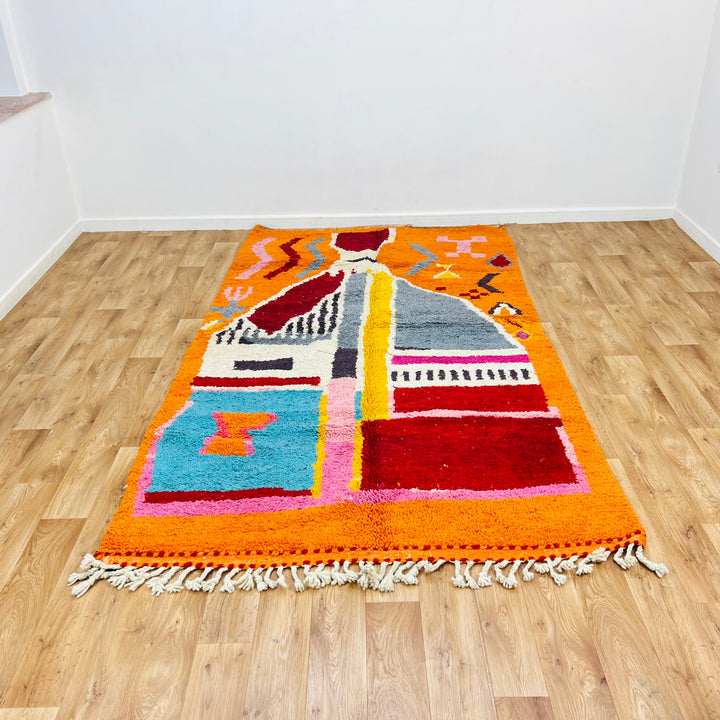 Vintage Moroccan rug 9x5 ft with vibrant orange abstract tribal design, handcrafted Berber style, perfect as an area rug or decor.