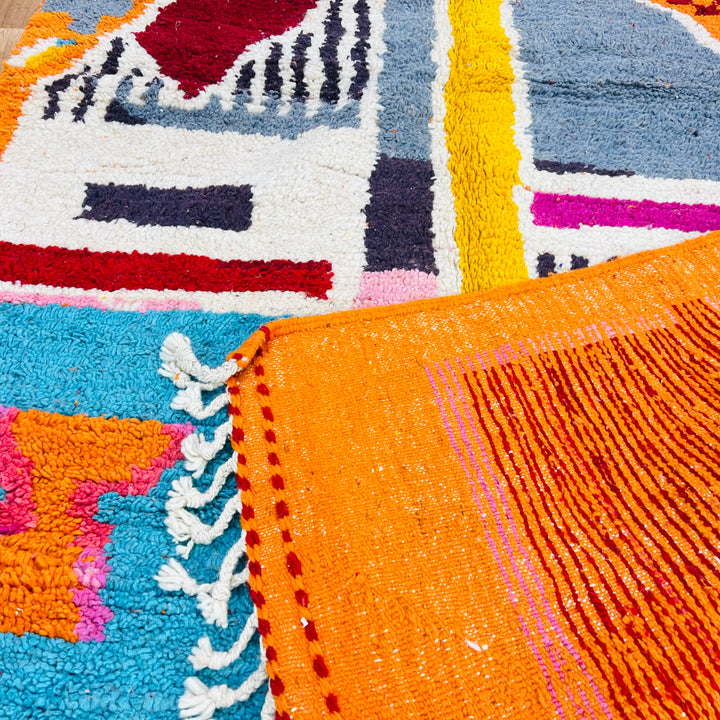 Vintage Moroccan rug with orange abstract tribal design in vivid colors, 9x5 ft, handcrafted from 100% natural wool.