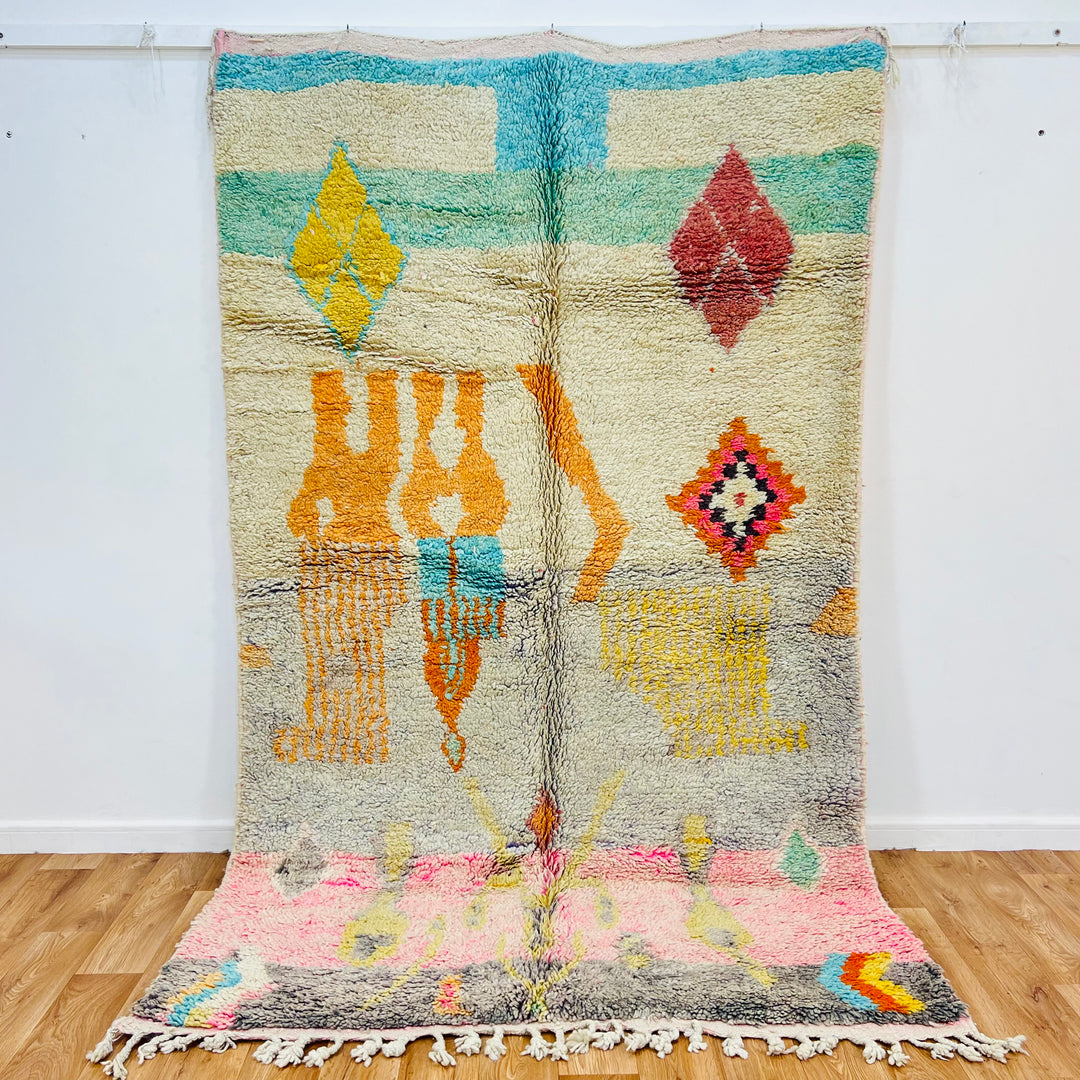 Vintage Moroccan rug with tribal patterns and pastel colors, handmade from wool, measures 8.5x5.1 ft, ideal for boho decor.