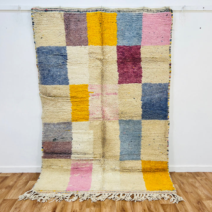 Colorful vintage Moroccan run with geometric patterns in pink, yellow, and blue, handmade by Berber artisans, perfect for eclectic decor