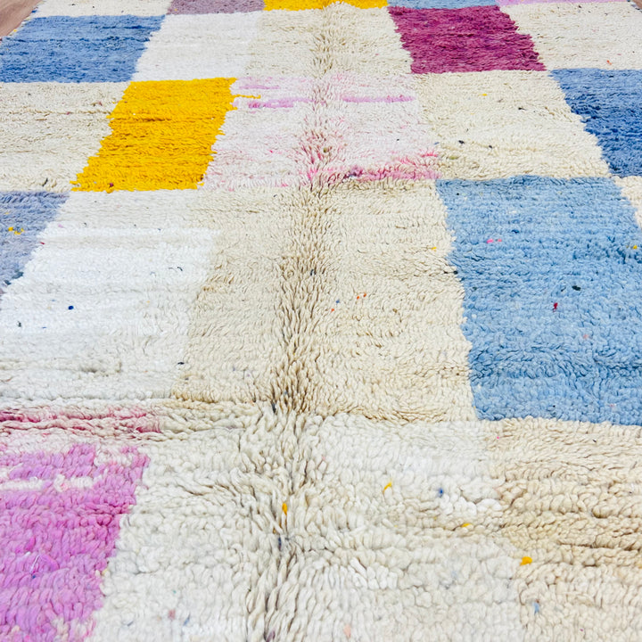Colorful vintage Moroccan rug with geometric patterns in vibrant pink, blue, and yellow, handmade by Berber artisans. Moroccan rug 8x10.