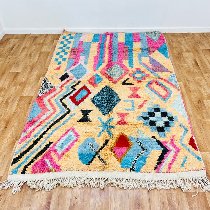 Vintage Moroccan rug with pink, turquoise, diamond patterns, handcrafted from wool. Ideal for boho interiors. Size: 8.5x5.3ft.