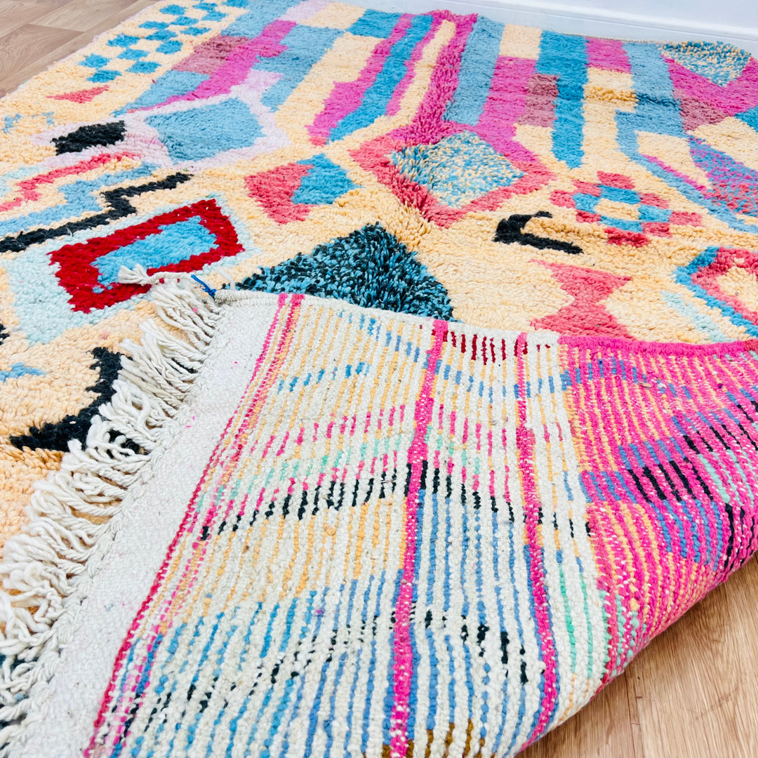 Vintage Moroccan Berber rug in pink, turquoise, and black with diamond and tribal motifs, handcrafted from 100% wool, 8.5x5.3ft.