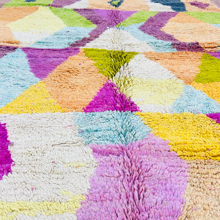 Colorful geometric Moroccan wool rug with vibrant patches of pink, yellow, and green, handmade by Berber artisans. Rug 419.