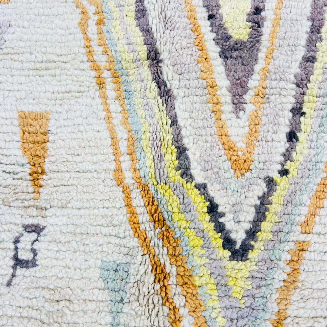 Pastel Moroccan rug with diamond and tribal patterns in pink, gold, and gray, handwoven in Atlas Mountains, 246x150 cm.