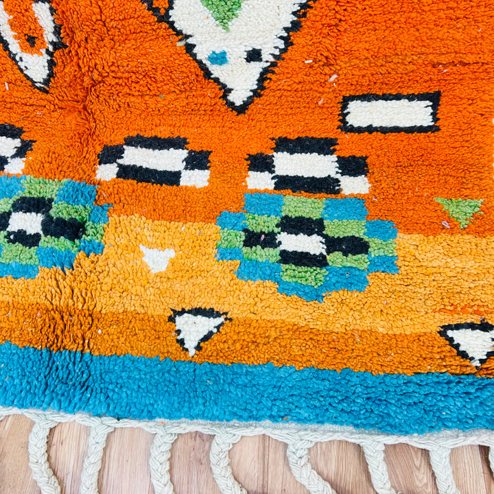 Colorful Moroccan wool rug with tribal motifs in hot pink, orange, blue, and ivory. Handmade, 254 x 150 cm. Moroccan Berber rug.