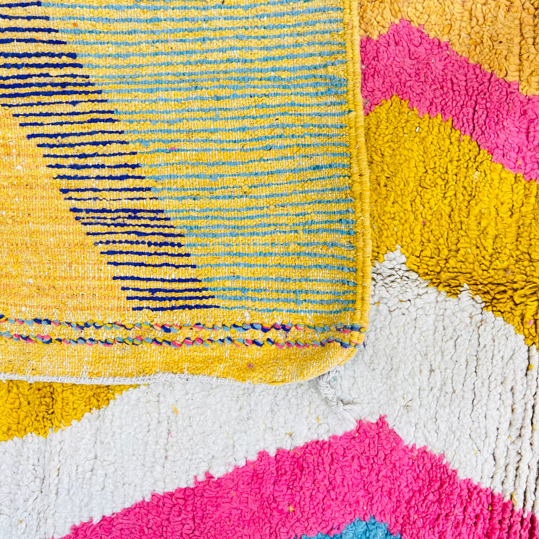 Colorful Moroccan shag rug with zigzag patterns in turquoise, pink, mustard, cream, and navy. Handmade, wool area rug. Size: 8.5 x 5 ft.