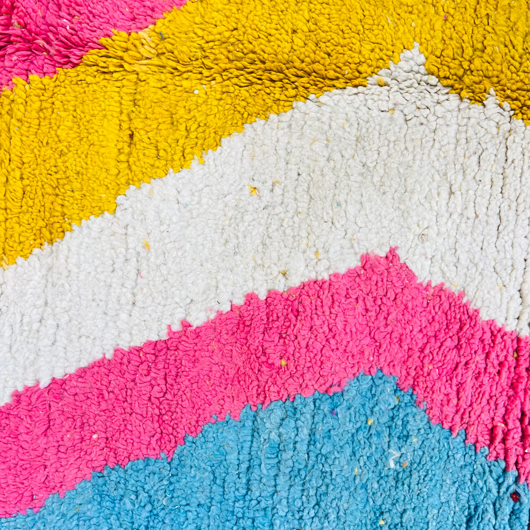 Colorful Moroccan shag rug with zigzag patterns in pink, yellow, cream, and turquoise. Handmade, 100% wool. 258 x 152 cm.