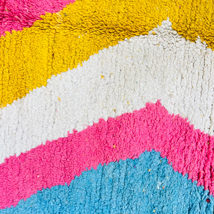 Colorful Moroccan shag rug with zigzag patterns in pink, yellow, cream, and turquoise. Handmade, 100% wool. 258 x 152 cm.