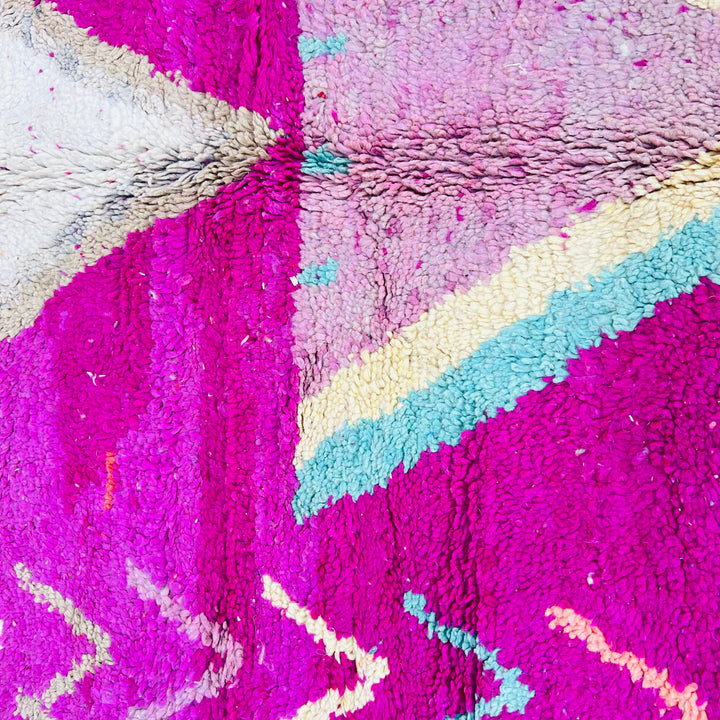Vintage Moroccan wool rug with vibrant magenta, turquoise, and pink tribal patterns, handcrafted by Berber artisans.