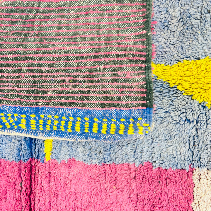 Vintage Abstract Moroccan Rug with vibrant pink, blue, yellow geometric design; 100% wool, 258x155 cm.