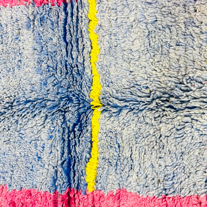 Vintage Moroccan wool rug in abstract pink, blue, and yellow design with geometric patterns, 258 x 155 cm, traditional Berber style.