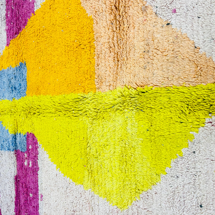 Close-up of vintage Moroccan wool rug with abstract pink, blue, yellow, orange geometric design, 258 x 155 cm.