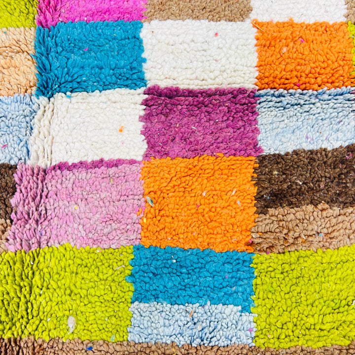 Vintage Moroccan rug with vibrant pink, orange, teal, lime, and cream checkerboard and Berber symbols, 100% wool, size 247 x 157 cm.