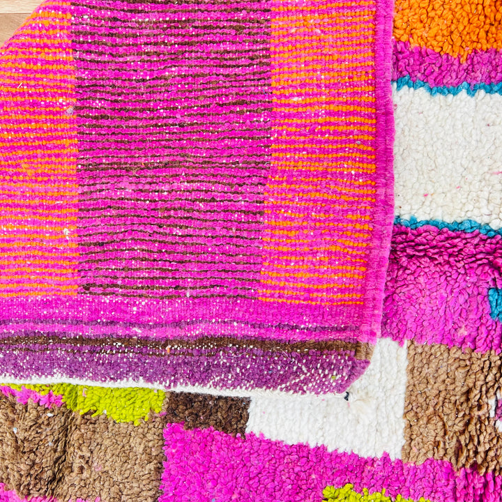 Vintage bright Moroccan rug with pink, orange, teal, lime, and brown hues, featuring Berber symbols. Handwoven, 100% wool.