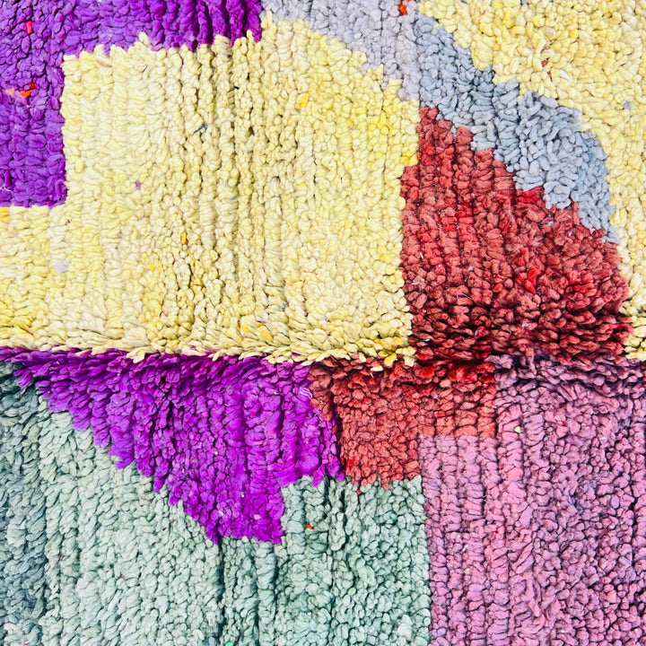 Colorful vintage Moroccan rug with abstract blocks in green, purple, yellow, blue, and burgundy. Handwoven by Berber artisans.