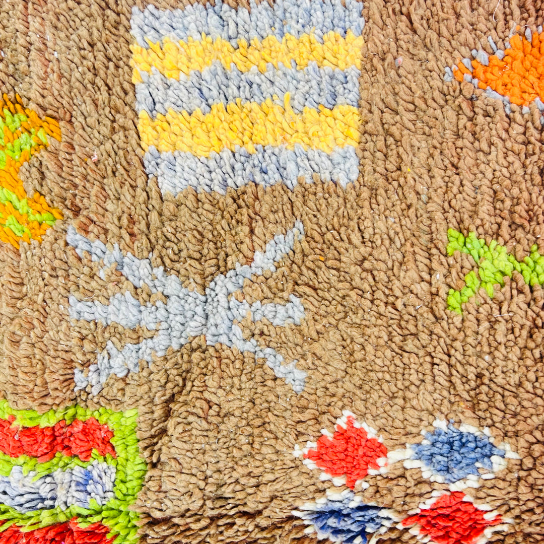 Handwoven vintage Moroccan rug with Berber symbols and earthy tones, featuring colorful abstract patterns, 263 x 150 cm.