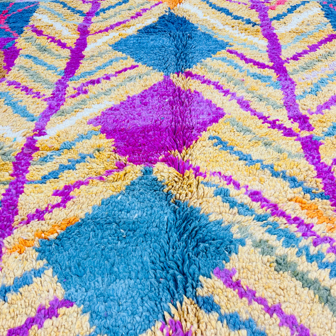Colorful vintage Moroccan wool rug with ochre, fuchsia, teal, and orange geometric patterns, handmade by Berber women.