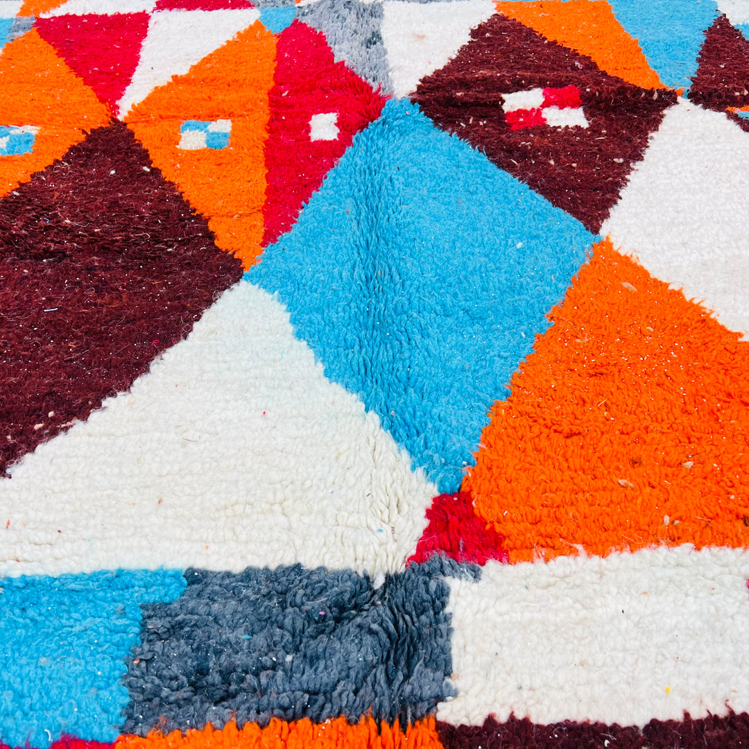 Colorful vintage Moroccan Berber rug with geometric design in burnt orange, sky blue, and cream