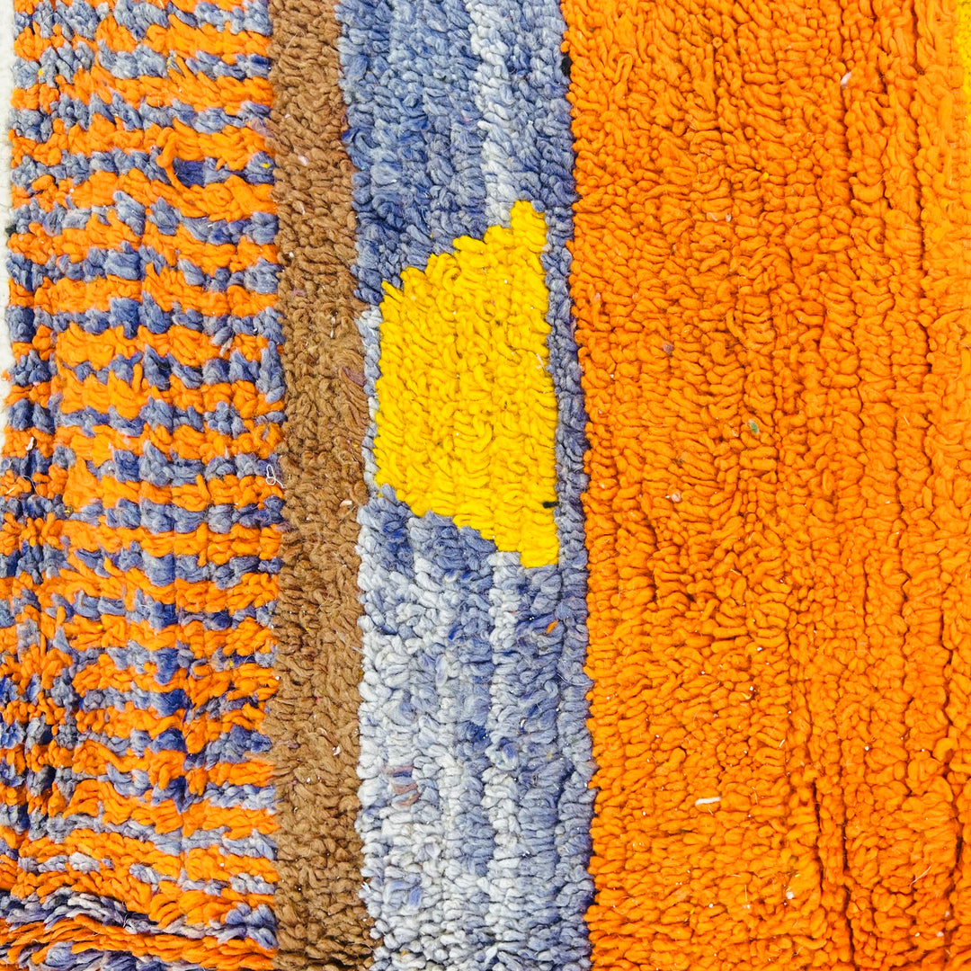 Colorful vintage Moroccan wool rug with geometric patterns in orange, yellow, and blue. Ideal for Moroccan style decor.