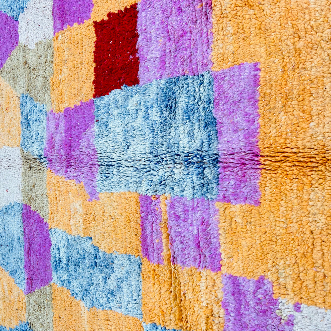 Colorful Diamond Vintage Moroccan Rug with vibrant harlequin pattern in red, coral, ochre, and blue. Traditional Berber handmade piece.