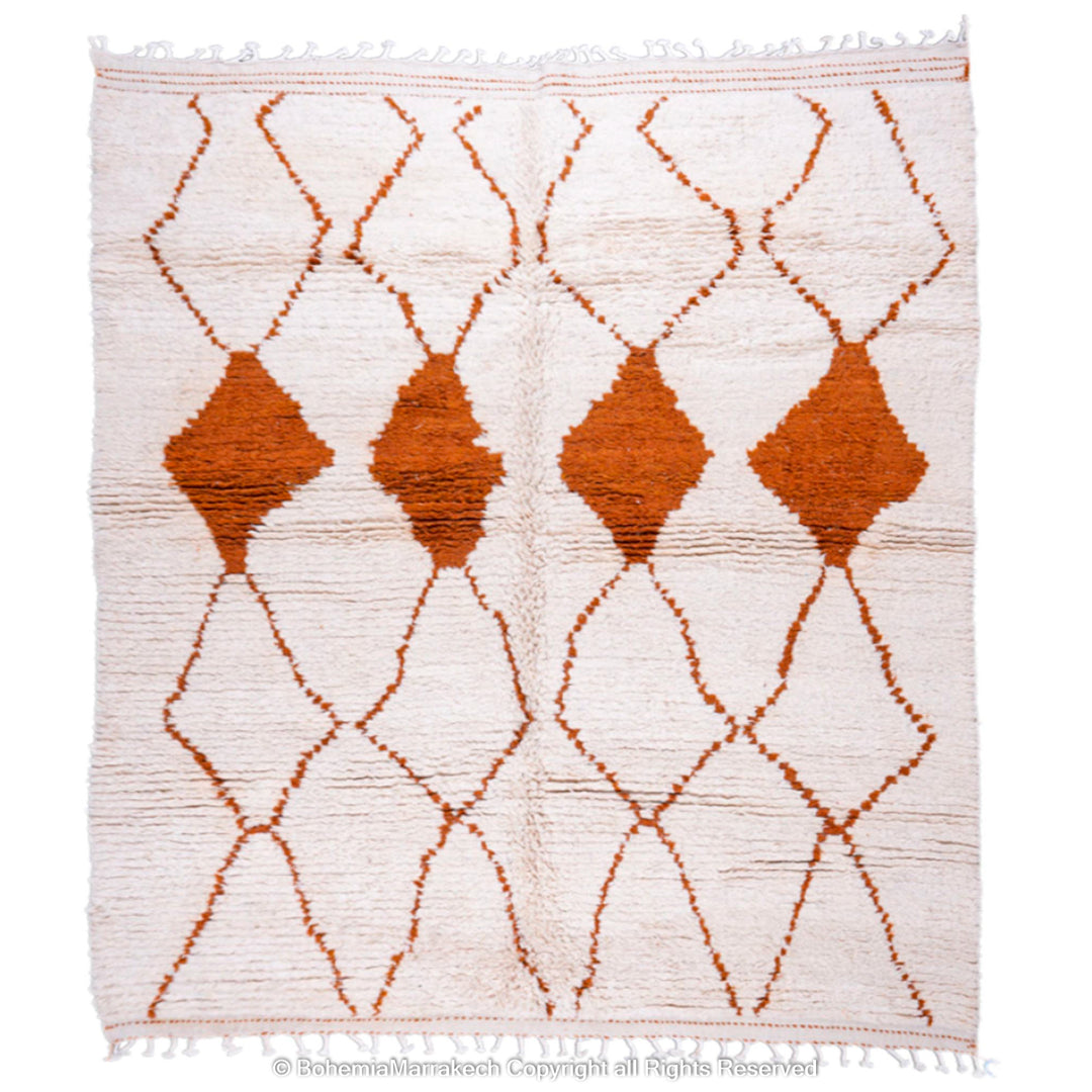 Handmade white Moroccan rug with rust diamond design, crafted from natural wool, featuring traditional Beni Ourain lattice pattern.