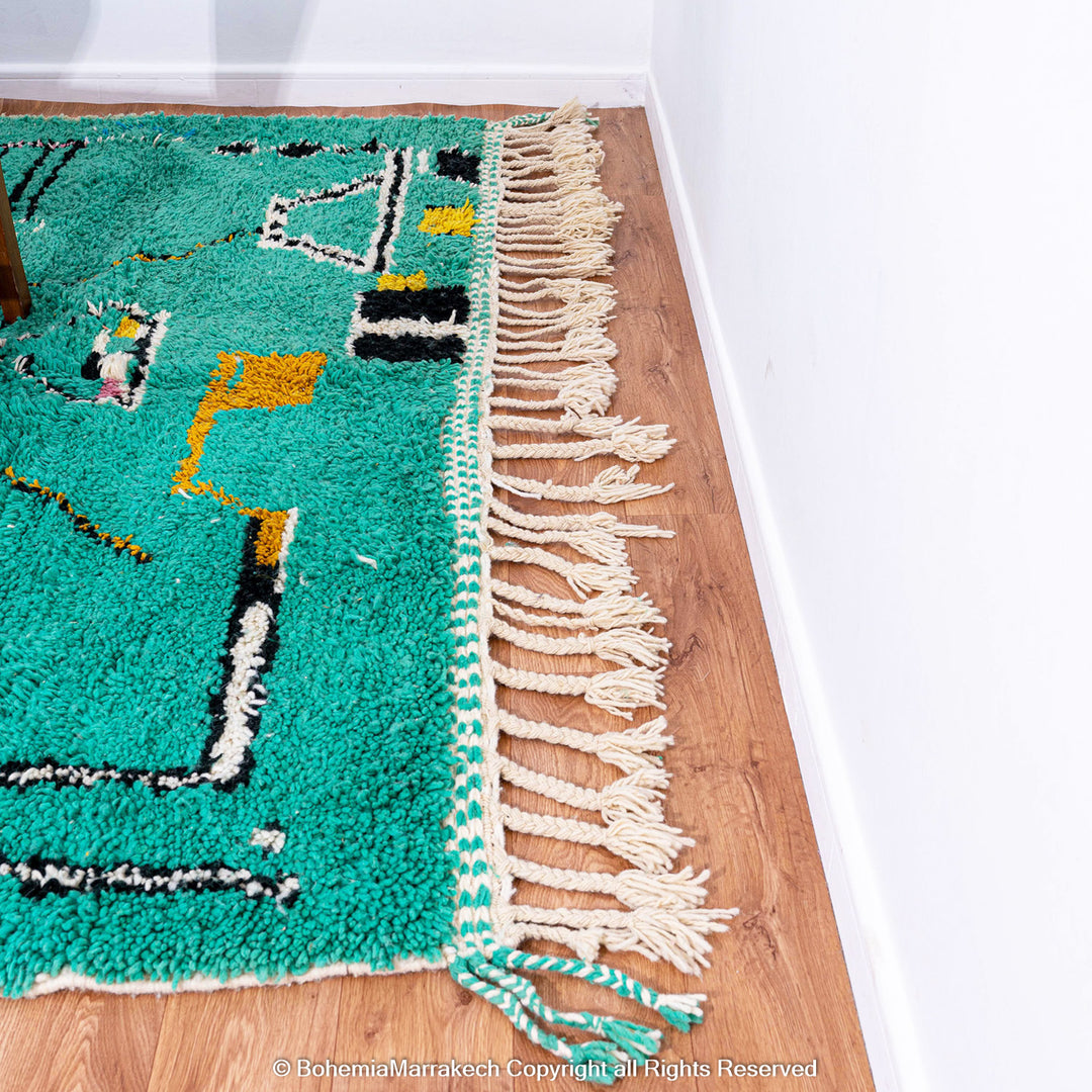 Handwoven green Moroccan Boujad rug with abstract Berber lines and colorful wool symbols