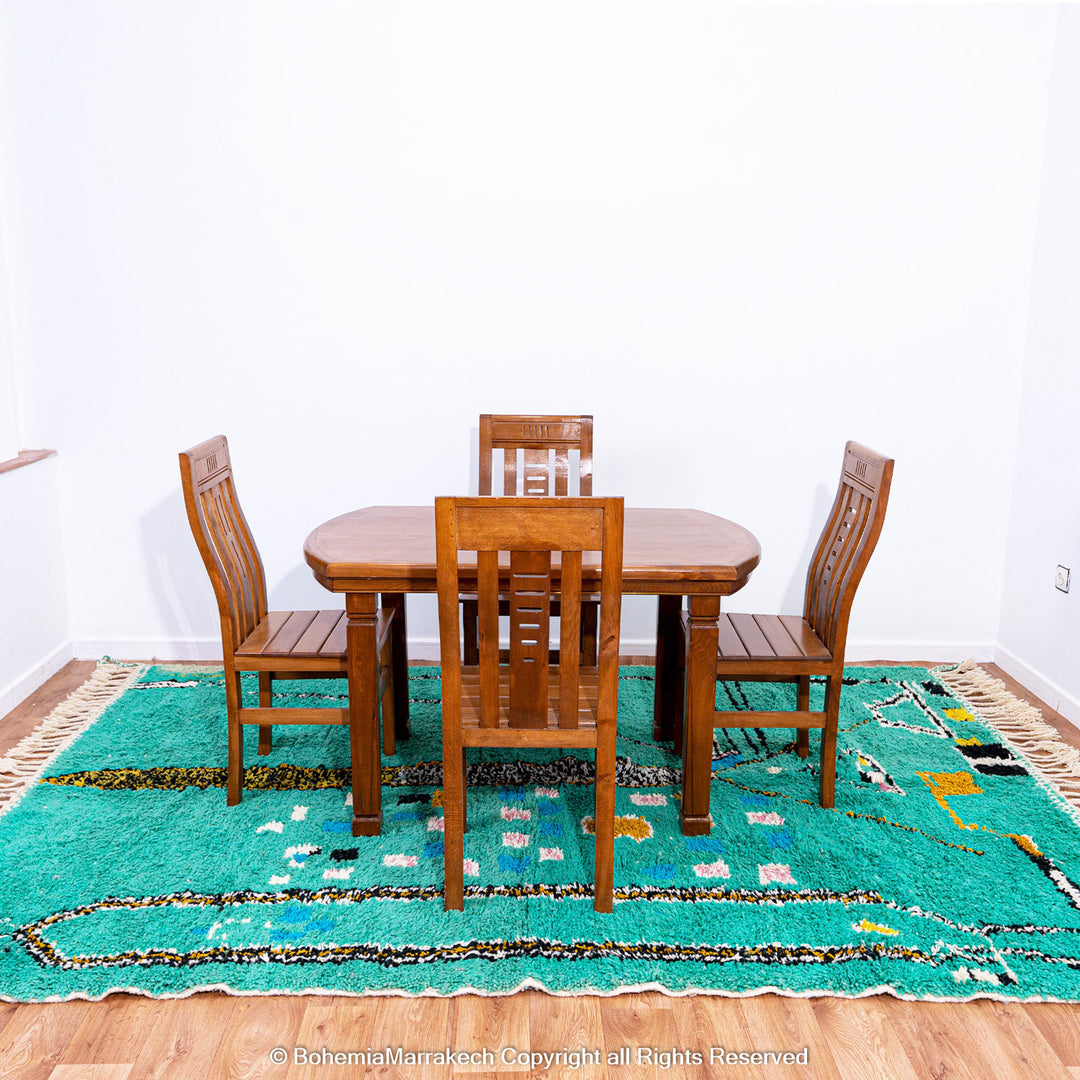 Handwoven green Moroccan Boujad rug with abstract Berber lines and colorful wool symbols