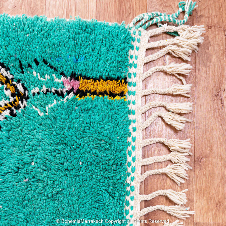 Handwoven green Moroccan Boujad rug with abstract Berber lines and colorful wool symbols