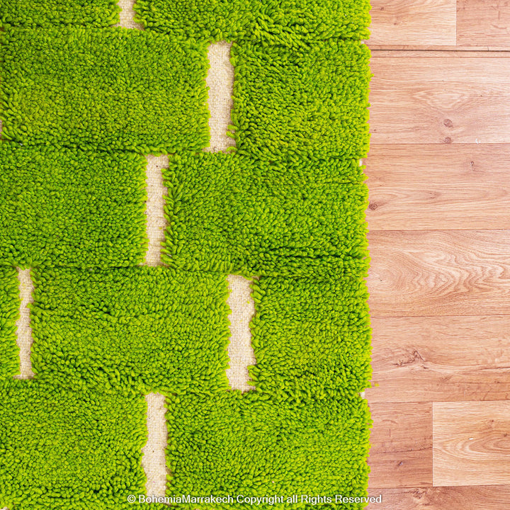 Handmade Moroccan rug in green checkered brick design, crafted from soft wool by Berber artisans