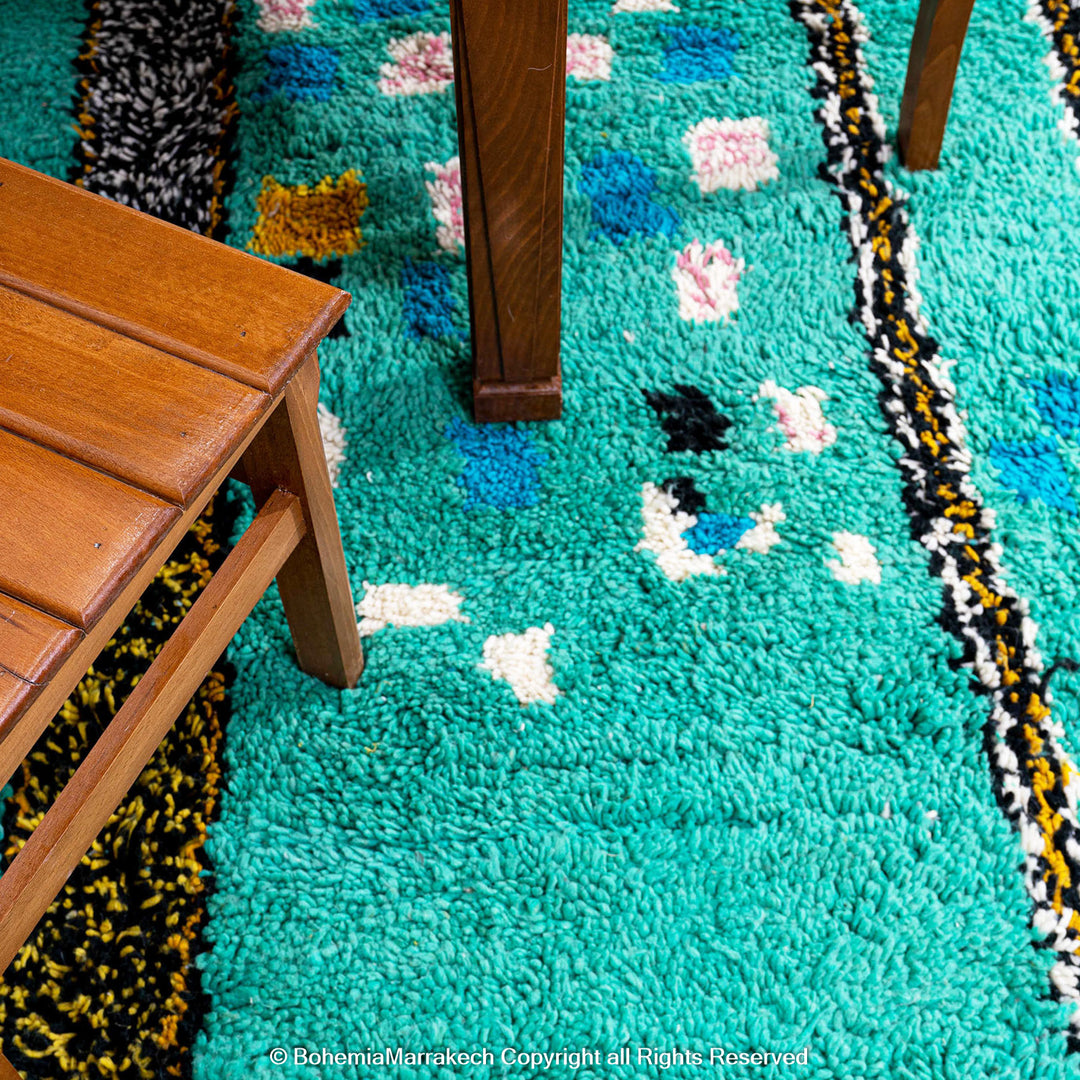 Handwoven green Moroccan Boujad rug with abstract Berber lines and colorful wool symbols