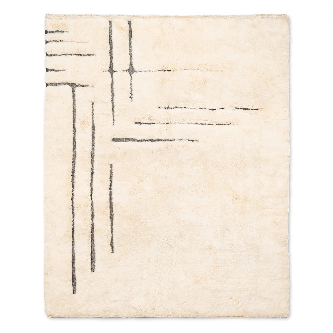 Minimalist Moroccan wool rug with black abstract lines, handwoven Beni Mrirt design, perfect for modern spaces.