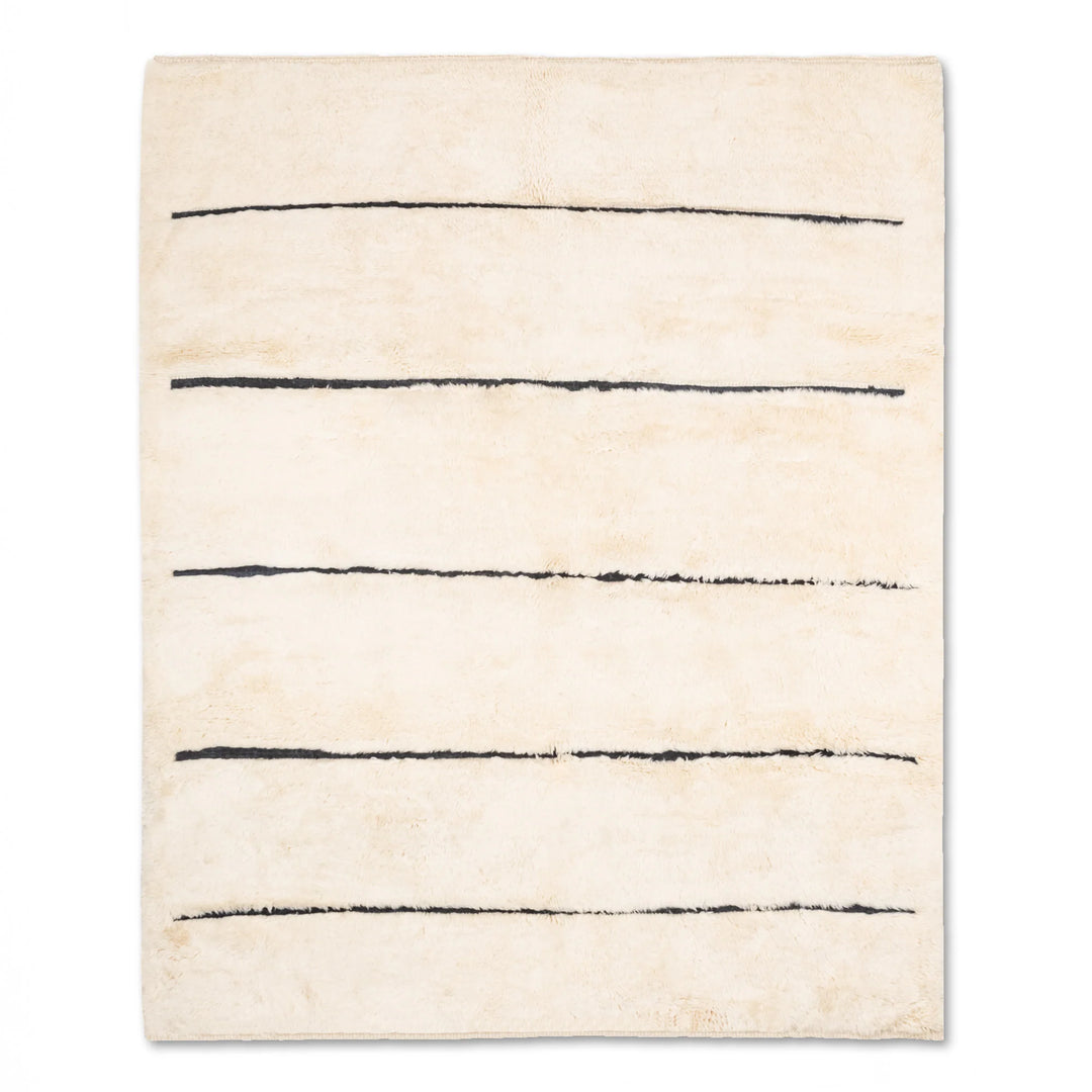 Minimalist Moroccan wool rug with black stripes on cream, handmade by artisans. Perfect for modern interiors. 8x10 area rug.