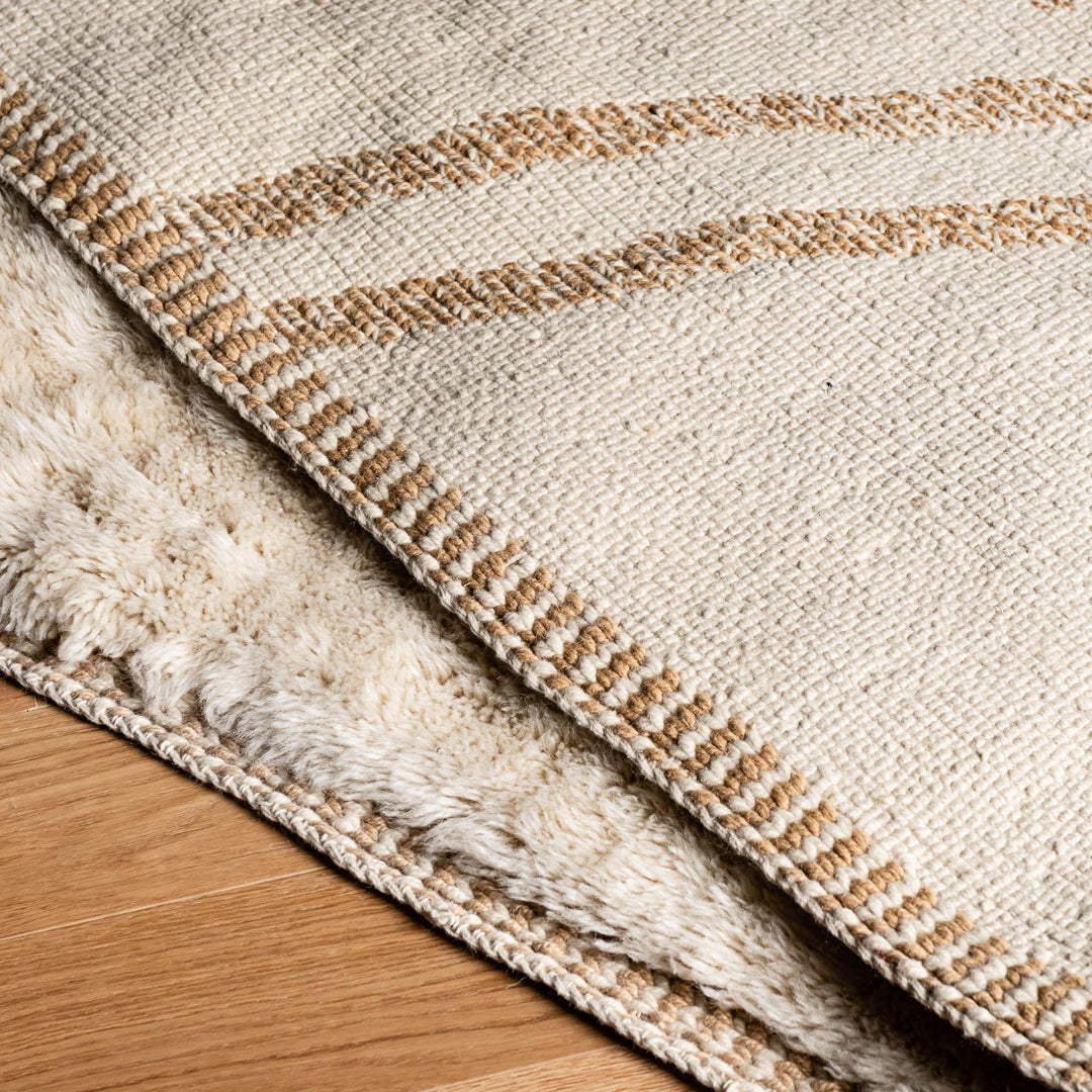 Minimalist cream Moroccan Beni Mrirt rug with subtle X-shaped design, handmade from natural wool, perfect for modern interiors.
