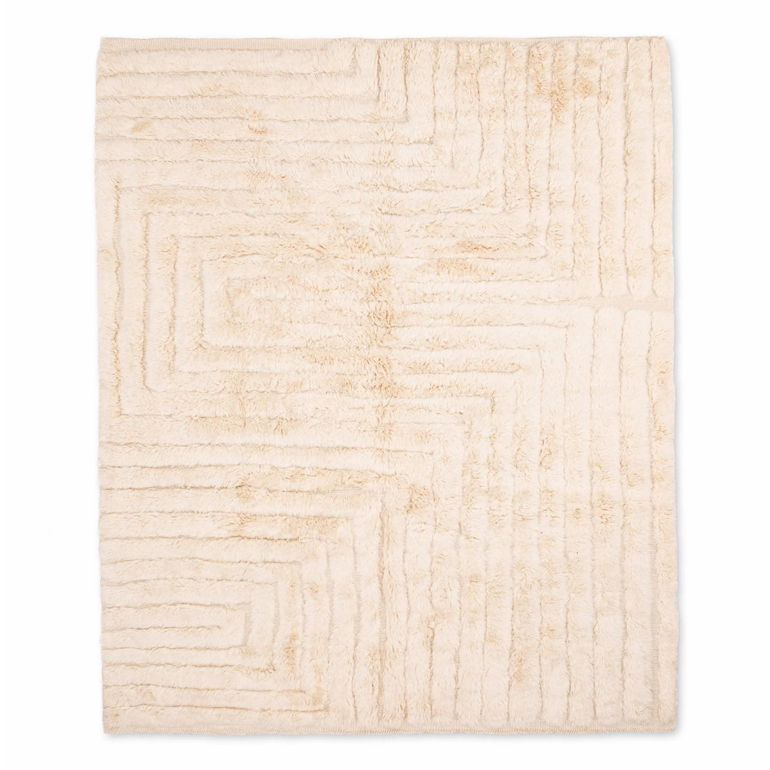 Beige minimalist Moroccan rug with geometric pattern, handwoven from soft wool, ideal for modern interiors; Moroccan rug for sale.