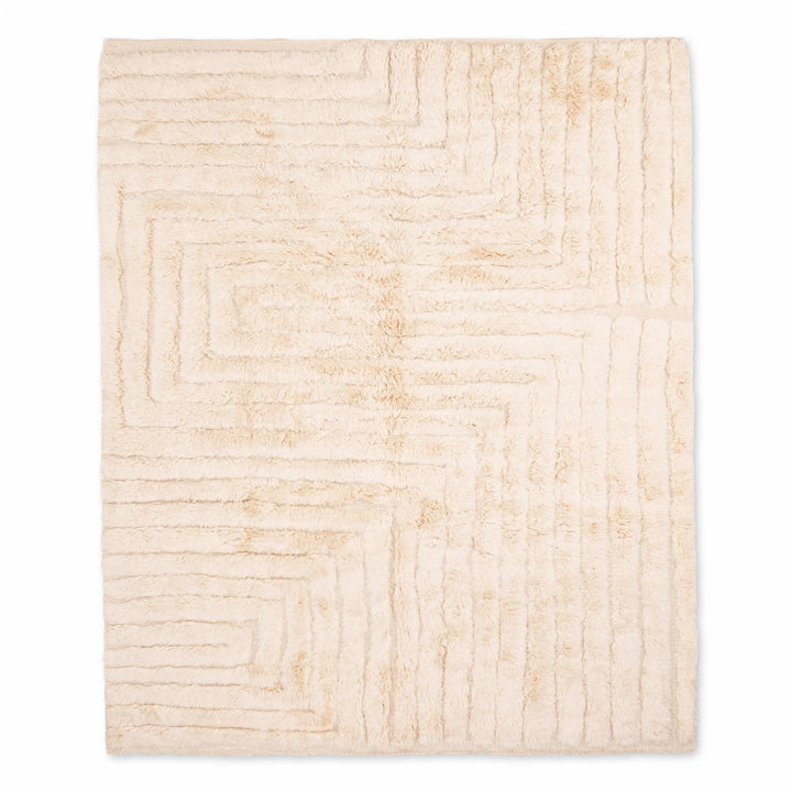 Beige minimalist Moroccan rug with geometric pattern, handwoven from soft wool, ideal for modern interiors; Moroccan rug for sale.