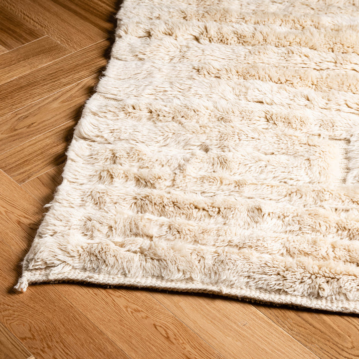 Minimalist custom Moroccan rug with soft wool and geometric design on wooden floor, perfect for modern interiors.