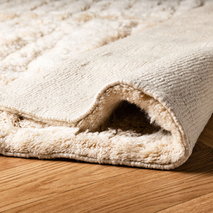 Close-up of a soft wool minimalist Moroccan rug with a geometric pattern, handwoven for modern interiors.