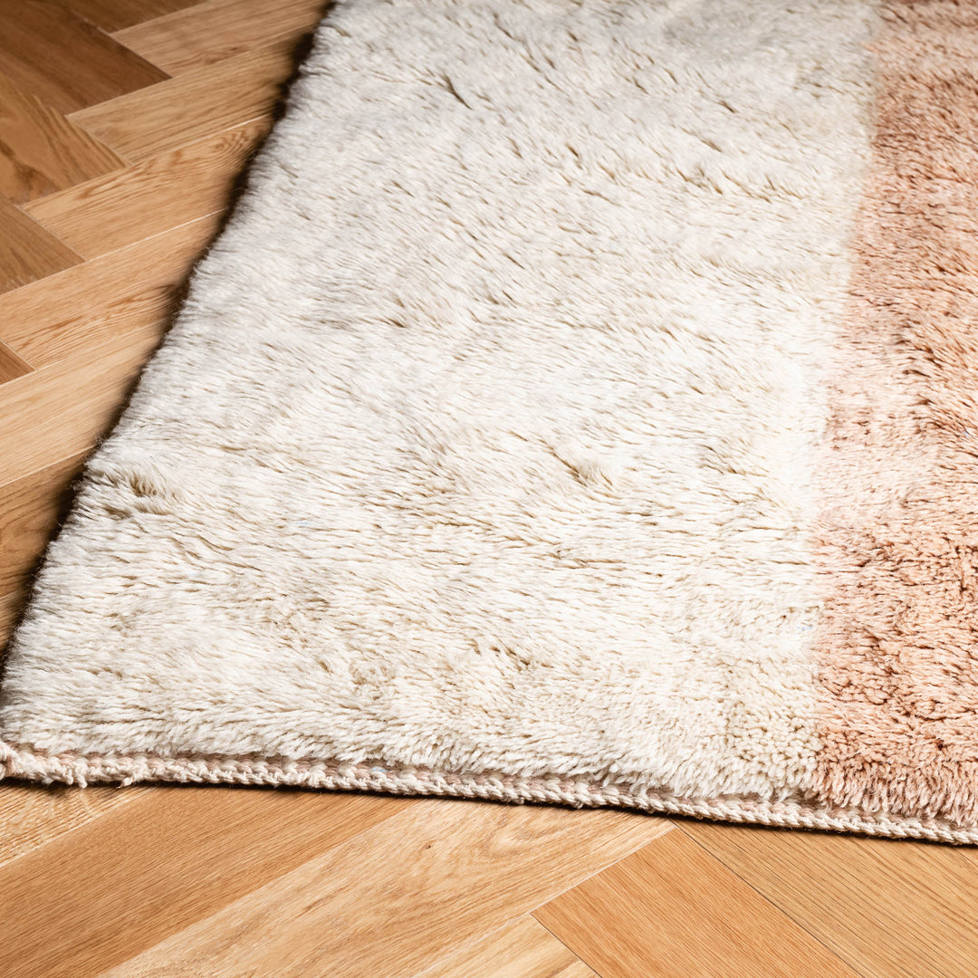 Minimalist Moroccan wool rug with peach and cream tones, featuring twin stripes, ideal for bedrooms or living spaces. Handmade and customizable.