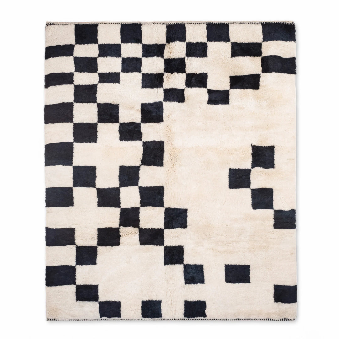 Modern Beni Mrirt Moroccan rug with black and ivory checkerboard design, showcasing handwoven wool texture and abstract artistry.