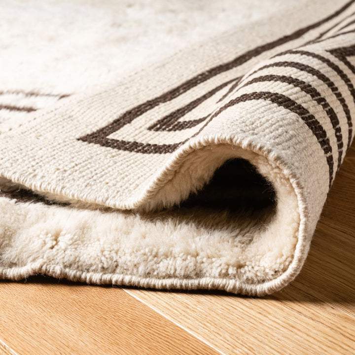 Close-up of Modern Beni Mrirt Moroccan wool rug with geometric border on ivory base, showcasing plush texture and elegant design.