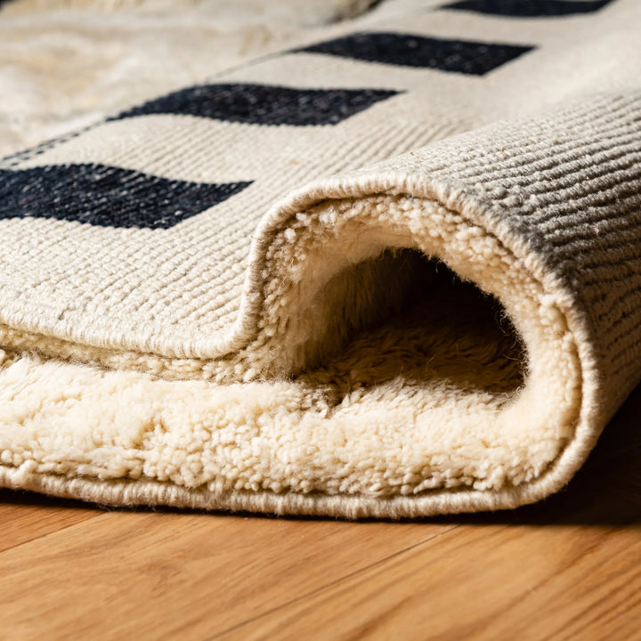 Modern Checkerboard Moroccan wool rug with black and ivory design, showcasing handmade detail and plush texture.