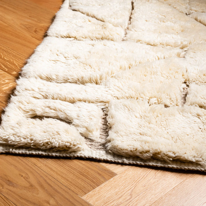 Modern cream Moroccan rug with plush wool texture and abstract geometric design, ideal for living rooms or minimalist interiors.