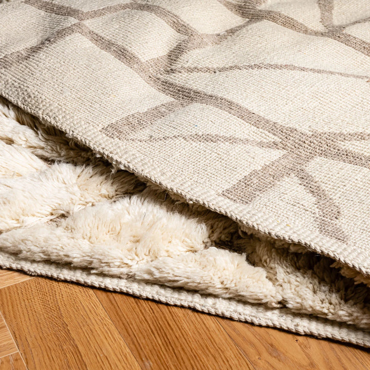Soft plush Moroccan rug with geometric design, natural wool, perfect for living rooms or bedrooms, handmade by artisans.
