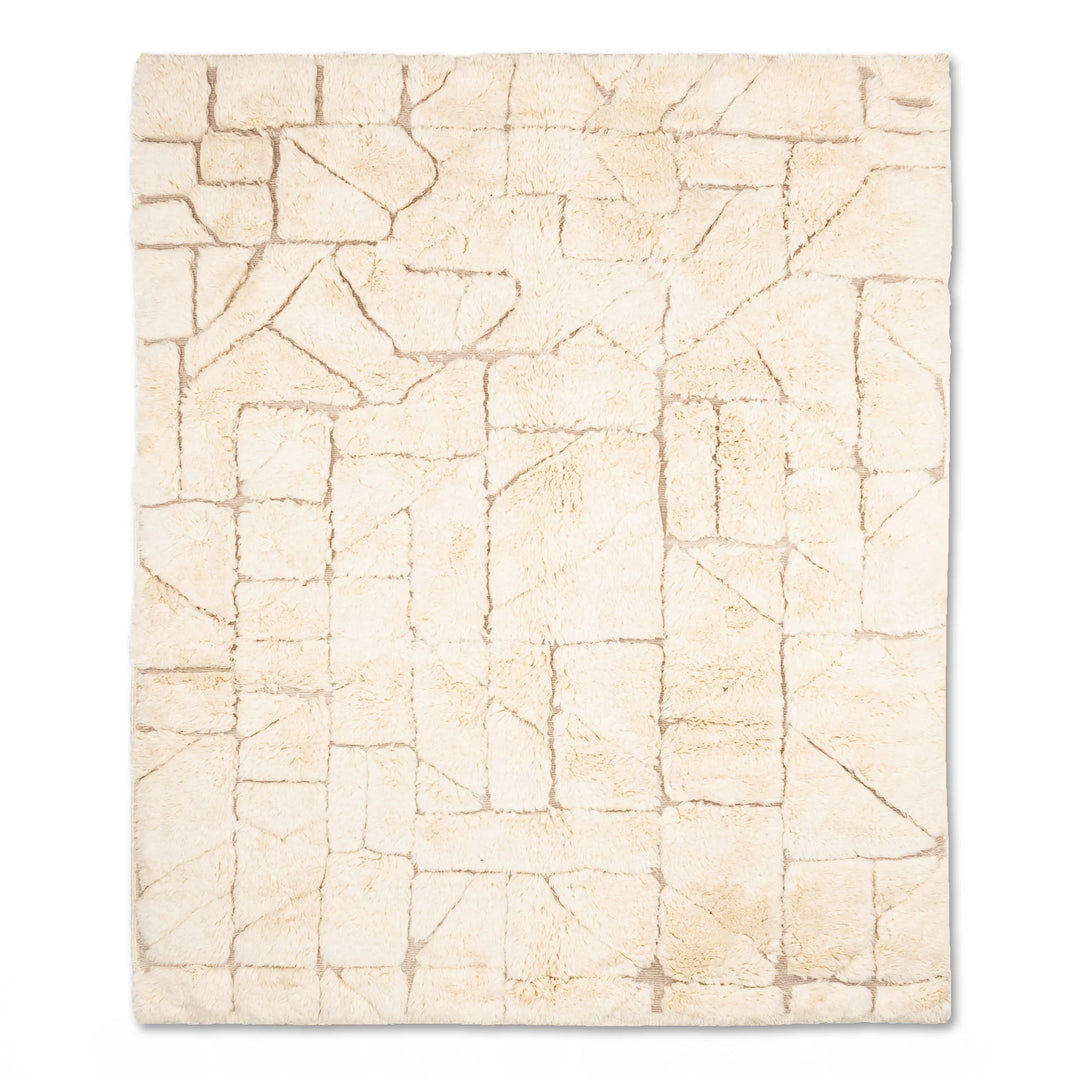 Modern cream Moroccan rug with geometric patterns, soft plush texture, made of natural wool, perfect for living rooms or bedrooms.